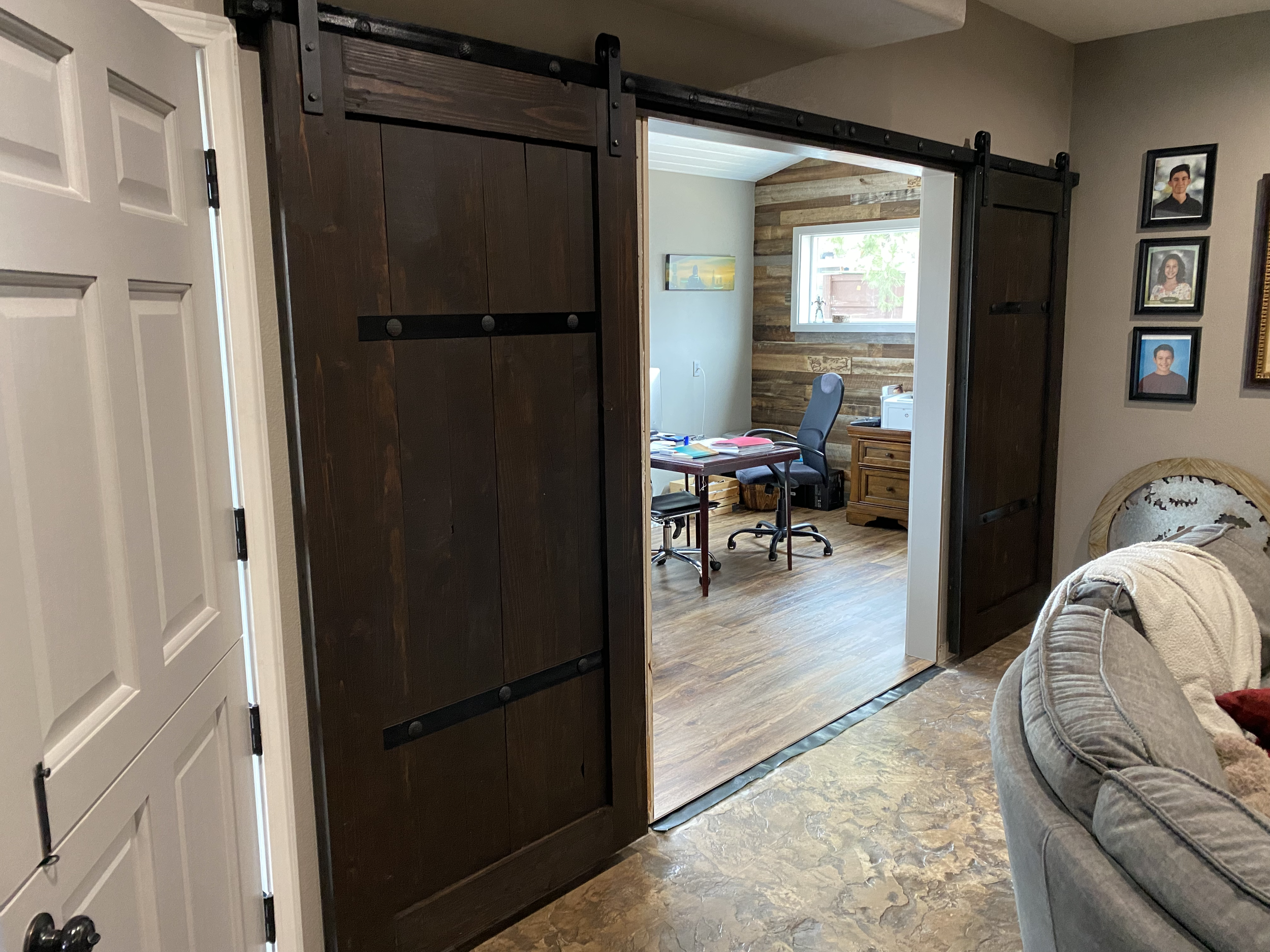 double door sliding barn door medieval walnut colored wood planks with metal straps and clavos studs